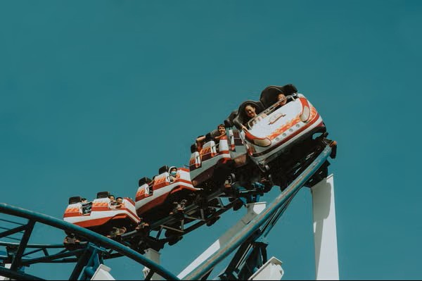 Roller coaster at a theme park under a blue sky