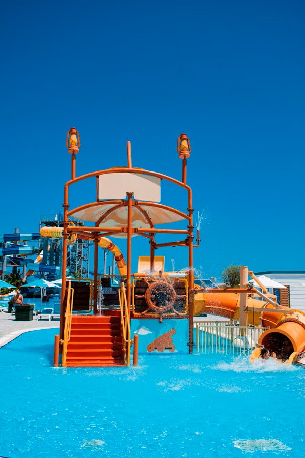 Colourful water park slides under a blue sky
